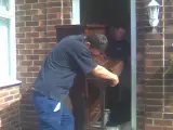 Piano Moving is never easy !
Even for one of the best in the business with Jonills.
And yes they usually have one our padded 
covers over them but often modern pvc doors
are to narrow so you have to take the cover 
off and use your 40 years  of skill to go through
a door with no damage to the piano
or the customers property !: Click Here To View Larger Image